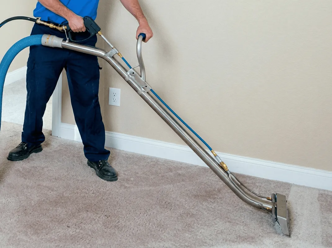 Professional operating a liquid removal machine on a carpeted floor in Columbia, SC